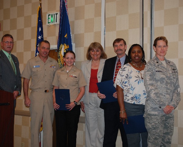 Together at the April meeting are (l-r) Vanderlip; Rear Adm. Terry Kraft, USN, commander, Navy Warfare Development Command; Petty Officer Third Class Mclelland; Duvall; Dr. John Wittman, AFCEAN of the Month; Teresa Irons, Civilian Cyber Professional of the Month; and Lt. Col. Jenniffer Romero, USAF, chapter member.